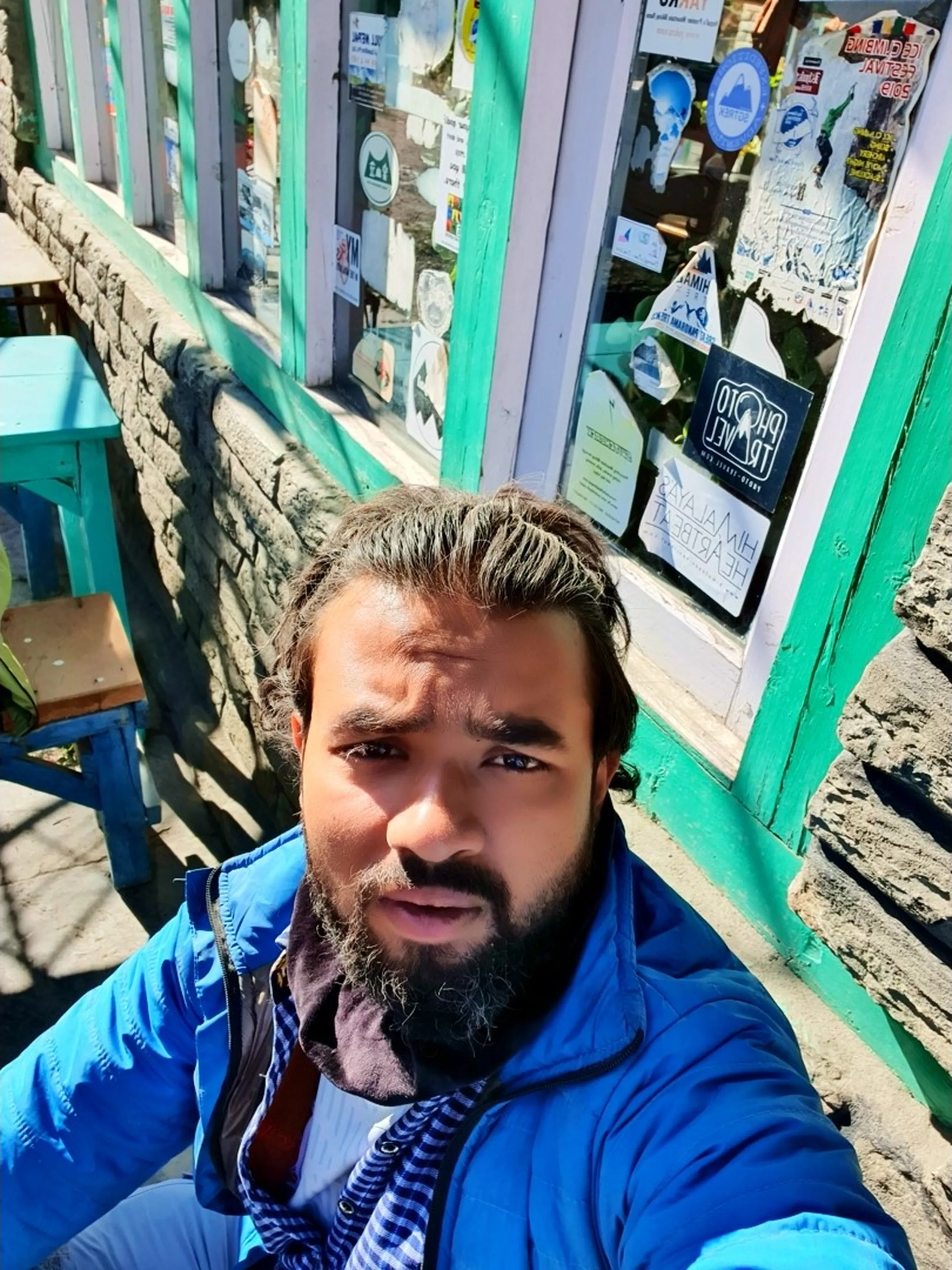 Hilarious close-up selfie of dust-covered exhausted male trekker with wild dishevelled hair and wide expressive eyes after long rough Bolero jeep ride on unpaved dusty mountain roads from Manang to Besisahar Nepal Annapurna Circuit trek end journey humor travel photography real trekking experience Nepal adventure dust road funny travel moment