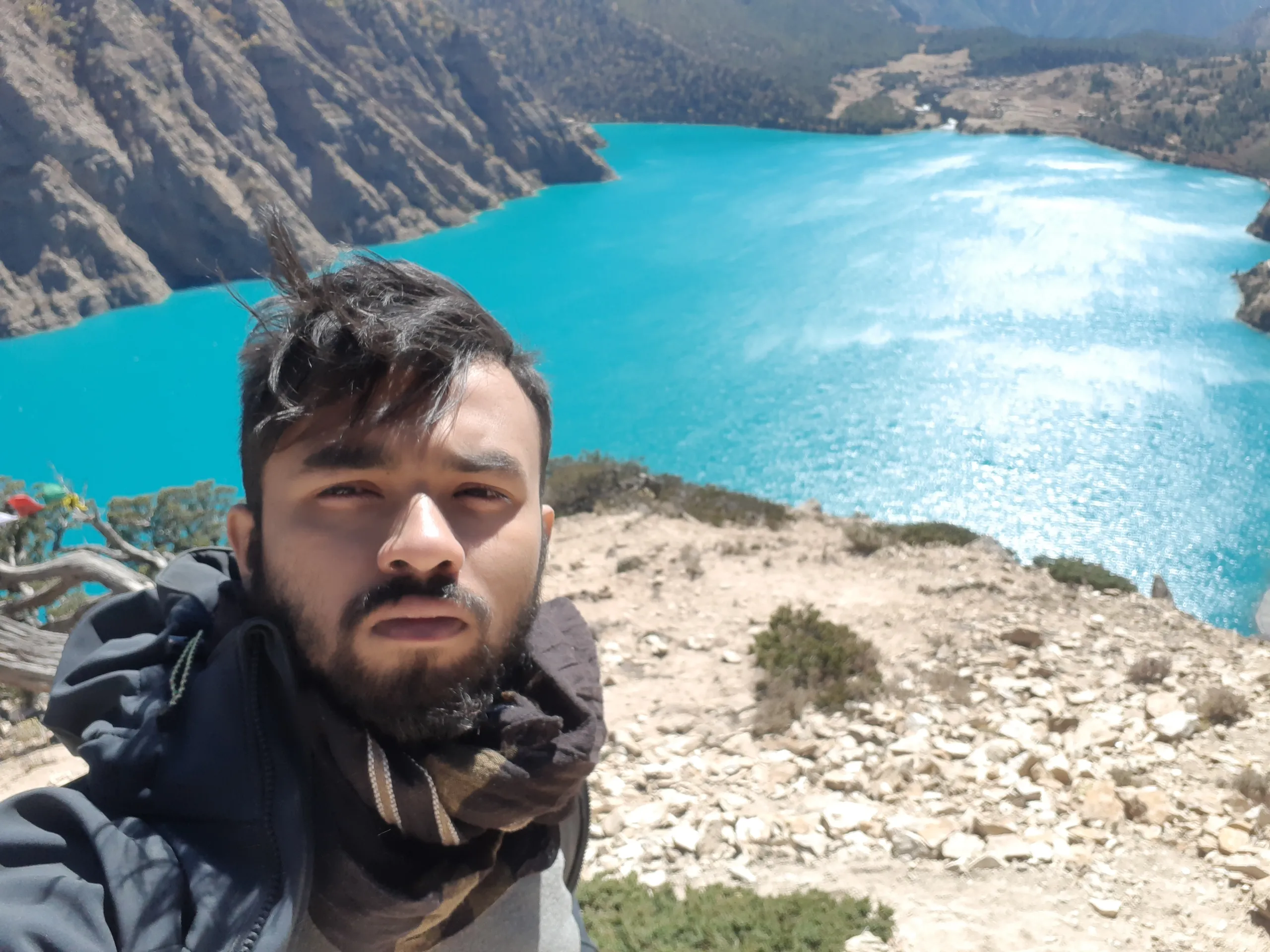 Trekker resting Phoksundo Lake tranquility